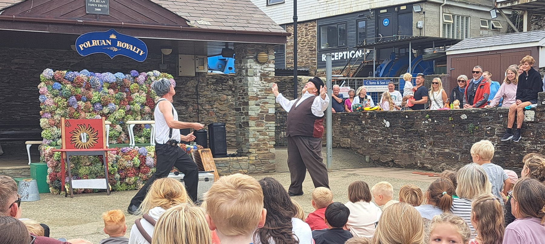 Quayside entertainers juggling for the Regatta crowd in 2026